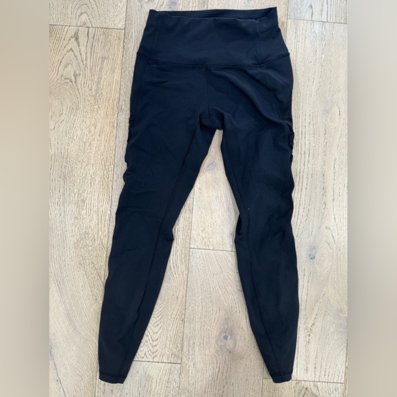 Lululemon black high-rise leggings. Side criss-cross mesh detail. Size 4 - Picture 2 of 3